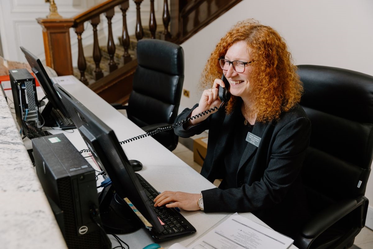 A hotel receptionist answering the phone.