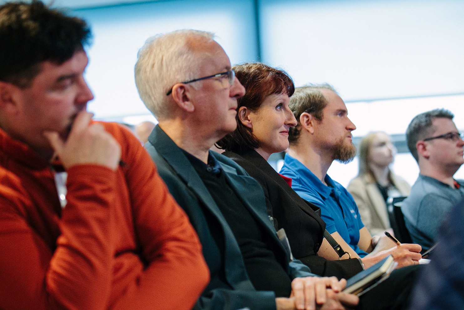 People sitting in a crowd at an event