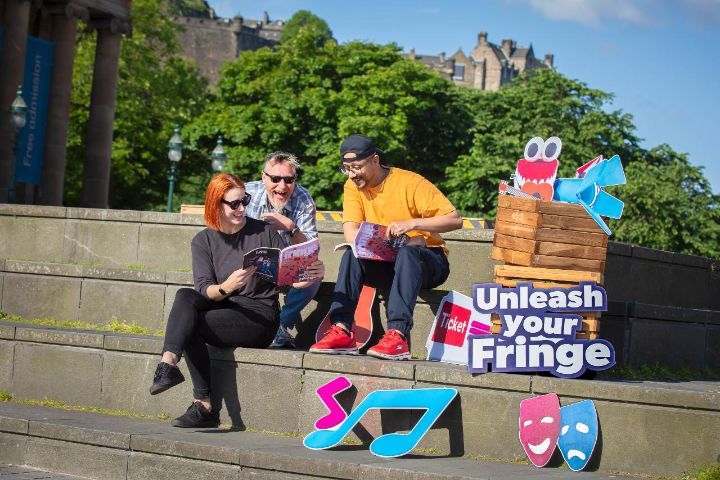 People reading Fringe programme