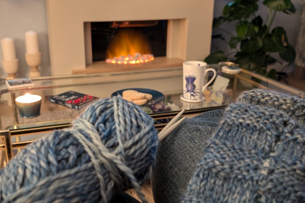 A cosy room with a roaring fireplace as part of the "coorie in" concept