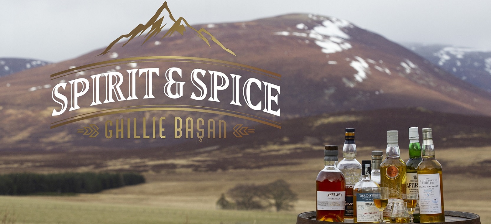 A selection of whiskies on a cask in the outdoors with Spirit and Spice logo superimposed