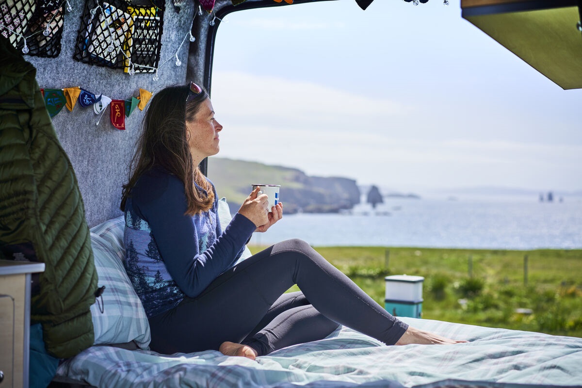 A visitor at Braewick Cafe & Campsite, overlooking the shore of Braewick Bay, Eshaness, Shetland