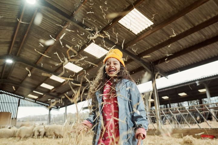 Girl playing in hay
