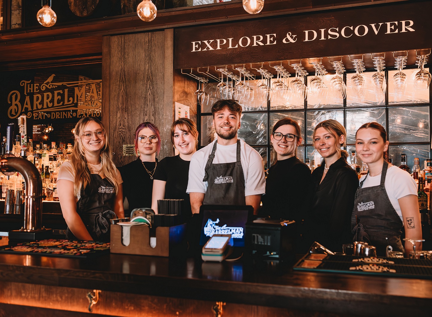 Staff of The Barrelman, standing smiling behind the bar.