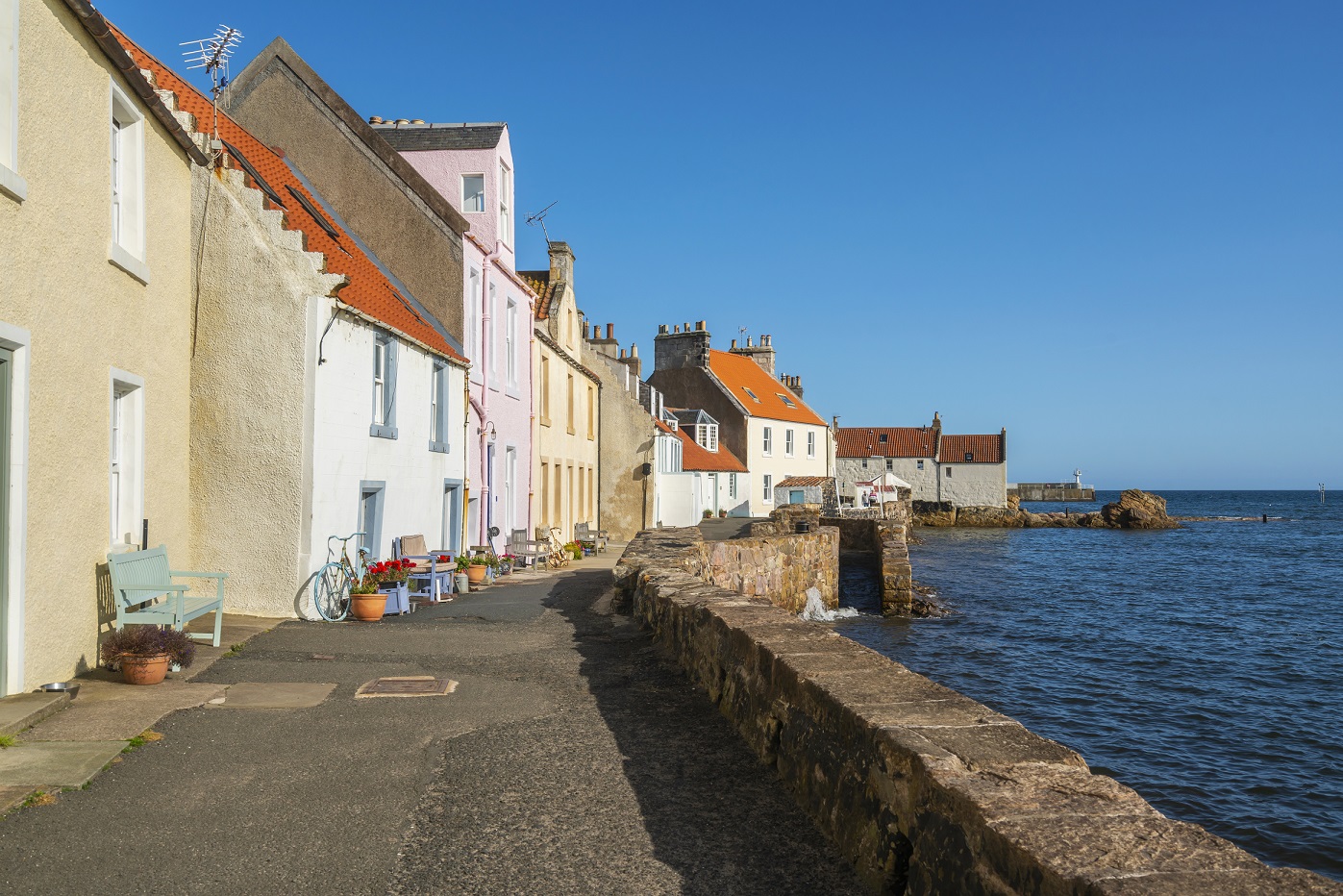 an images of small brightly coloured cottages overlooking the sea.