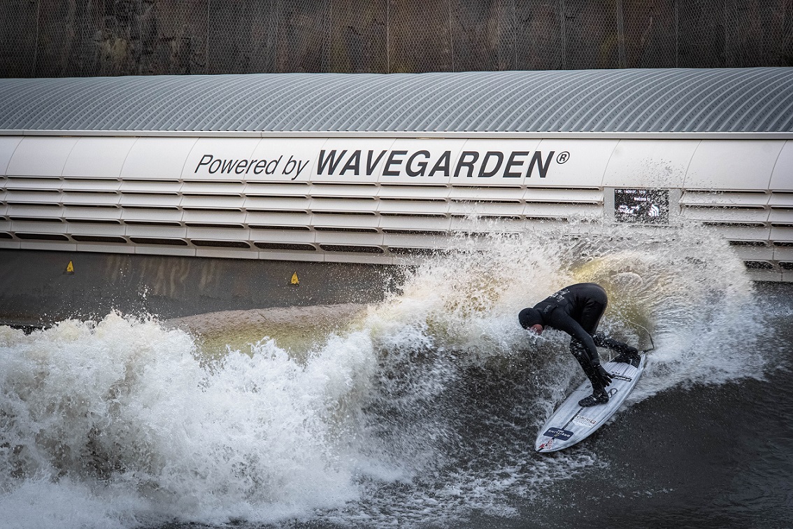 A person surfing waves in an outdoor surf resort